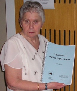 Christine Simpson with a bound copy of the UEB Rulebook